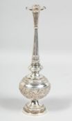 A LARGE INDIAN SILVER ROSEWATER SPRINKLER, the body with embossed floral decoration, the sprinkler