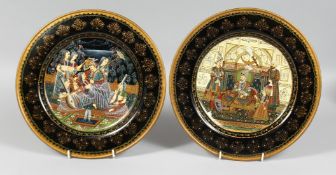 A PAIR OF INDIAN POLYCHROME LACQUERED WOOD PLATES, one painted with a seated dignitary and