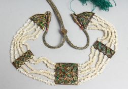 A FINE INDIAN SEED PEARL AND YELLOW METAL NECKLACE, the pendants inset with semi precious stones.