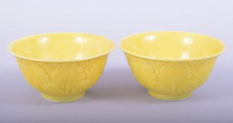 A PAIR OF CHINESE YELLOW GLAZED PORCELAIN CUPS, each with six character mark to base, 7.5cm