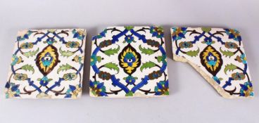 A SET OF THREE EARLY SAFAVID POTTERY TILES, each with the same decoration, white ground ith blue