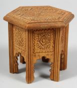 A SMALL CARVED WOODEN MODEL OF AN ISLAMIC TABLE, 9cm high.