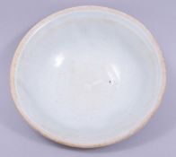 A CHINESE CELADON PARTLY GLAZED POTTERY BOWL, 15.5cm diameter.