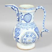 A TURKISH KUTAYHA BLUE AND WHITE POTTERY WATER JUG, with raised decoration and painted with