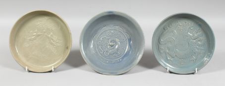 A GROUP OF THREE CHINESE GLAZED POTTERY DISHES, two with blue glaze and raised decoration