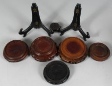 A COLLECTION OF EIGHT CHINESE HARDWOOD STANDS, various types / sizes, largest 14cm diameter, (8).