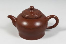 A LARGE CHINESE YIXING TEAPOT with fitted strainer, the inner lid and base with impressed marks.