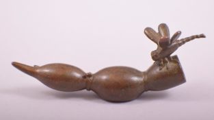 A JAPANESE BRONZE MODEL OF A DRAGONFLY ON A LOTUS ROOT, stamped underside, 9cm long.