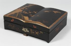 A JAPANESE LACQUERED WOOD GAMES BOX, the hinged lid opening to reveal four fitted boxes and covers