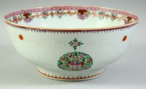 A CHINESE FAMILLE ROSE PORCELAIN BOWL, decorated with roundels of floral motifs, 25.5cm diameter.