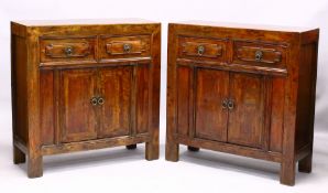 A PAIR OF CHINESE HARDWOOD CABINETS, each comprising two drawers above two doors, the hinged doors