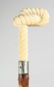 A CARVED BONE HANDLED WALKING CANE, the handle carved as a knotted rope, 87.5cm long.