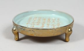 A CHINESE CELADON PORCELAIN TRIPOD CENSER, the exterior gilded, and with four-character mark to