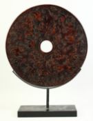 A LARGE CHINESE CARVED HARDSTONE BI-DISK, carved with chilong and stylised clouds, on fitted