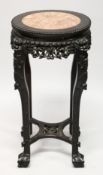 A CHINESE CARVED HARDWOOD AND MARBLE INSET VASE STAND, with pierced and carved frieze depicting