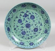 A CHINESE TURQUOISE-GROUND BLUE AND WHITE PORCELAIN DISH, decorated with stylised flowerheads and
