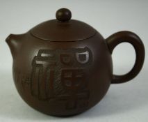 A SMALL CHINESE YIXING TEAPOT, with incised characters to the side and impressed mark to base,