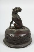 A BRONZE OKIMONO OF A MYTHOLOGICAL BEAST, atop a pierced koro cover, 12.5cm.