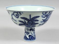 A CHINESE BLUE AND WHITE PORCELAIN STEM CUP, the exterior decorated with female figures in a