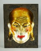 A CHINESE LACQUERED CONCAVE PICTURE OF A FACE, signed to reverse, 31cm x 24cm.