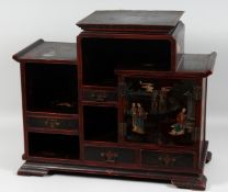 A 19TH CENTURY CHINESE LACQUERED WOOD CABINET, comprising two doors and three drawers, 50cm high,