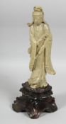 A LARGE CHINESE CARVED SOAPSTONE FIGURE of guanyin, mounted to a carved soapstone lotus and lily pad