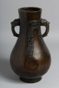 A CHINESE TWIN-HANDLED BRONZE VASE in the archaic style, with nine-character mark to base, 29cm