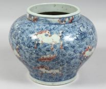 A CHINESE BLUE, WHITE, AND UNDERGLAZE RED PORCELAIN JAR, decorated with horses amongst stylised