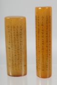 TWO CHINESE HARDSTONE SEALS WITH FINE INSCRIPTIONS TO THE SIDES. 8.5cm and 7.5cm long