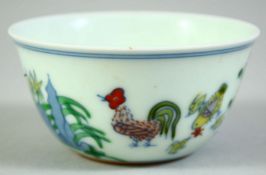 A CHINESE PORCELAIN CHICKEN CUP, the base with six character mark, 8cm diameter.
