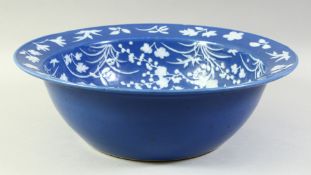 A LARGE CHINESE POWDER BLUE GROUND PORCELAIN BOWL, the interior decorated with various native