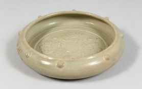 A CHINESE CELADON GLAZE CIRCULAR BRUSH WASHER, the interior with raised decoration depicting chilong