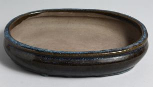 A JAPANESE DRIP GLAZED POTTERY BONZAI PLANTER, 33cm x 22cm.