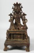 A GOOD SEATED BRONZE DEITY, raised on a plinth, supported by four legs. 24cm high