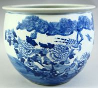 A CHINESE BLUE AND WHITE PORCELAIN PLANTER, painted with birds and native flora, 28.5cm diameter.