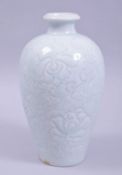 A CHINESE CELADON GLAZE POTTERY VASE, with incised floral decoration to the body, 22cm high.