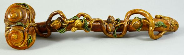 A CHINESE GLAZED POTTERY RUYI SCEPTER of naturalistic form, 33cm long.