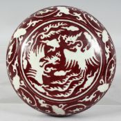 A CHINESE RED GLAZED CIRCULAR BOX AND COVER, the lid with white phoenix and incised decoration.