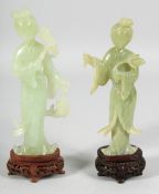 TWO CHINESE CARVED JADE FIGURES on fitted hardwood stands, each holding a flower, one holding a