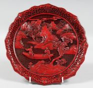 A CHINESE CINNABAR LACQUER DISH, depicting a scene with female figures in a boat, 24.5cm diameter.