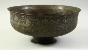 AN ISLAMIC TINNED COPPER PEDESTAL BOWL, with a band of engraved calligraphy to the rim. Possibly