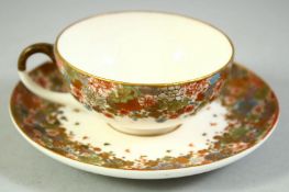 A SMALL JAPANESE SATSUMA CUP AND SAUCER, finely decorated with flowers and butterflies, each piece