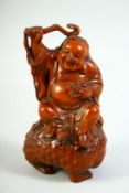 A GOOD CHINESE CARVED BOXWOOD FIGURE, of an immortal seated upon a beast, 14cm high.