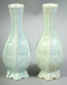 A SMALL PAIR OF CHINESE CELADON GLAZE POTTERY VASES, both of hexagonal form with raised panels of