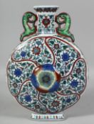 A LARGE CHINESE DOUCAI TWIN-HANDLED PORCELAIN MOON FLASK decorated all over with flowerhead and vine