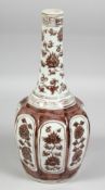 A CHINESE UNDERGLAZE RED OCTAGONAL BOTTLE VASE, decorated with panels of various floral motifs,