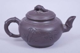 A CHINESE YIXING CLAY TEAPOT AND COVER of bamboo form, mark to base and underside of lid, 14cm spout