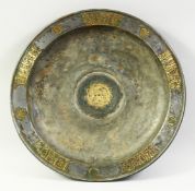 AN UNUSUAL LARGE ISLAMIC PEWTER DISH, with inlaid brass panels with engraved decoration, the