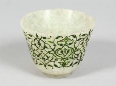 AN ISLAMIC JADE CUP, with incised decoration to the exterior, 8.5cm diameter.