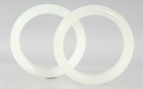 TWO CHINESE JADE BANGLES. 8cm diameter, 6cm internal diameter